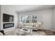 Bright living room with fireplace, modern furnishings, and a view of the neighborhood through expansive windows at 2918 Sloan Dr, Charlotte, NC 28208