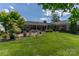 Well-manicured backyard with a brick patio, lush lawn, and beautiful landscaping at 3008 Imperial Dr, Gastonia, NC 28054