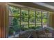 Window view of a lush backyard with manicured lawn, mature trees, and well-maintained landscaping at 3008 Imperial Dr, Gastonia, NC 28054