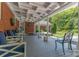 Spacious covered patio featuring comfortable seating, a ceiling fan, and a view of the manicured lawn at 3008 Imperial Dr, Gastonia, NC 28054