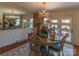 Elegant dining room featuring a chandelier, large mirror, and a view to the outdoor patio at 3008 Imperial Dr, Gastonia, NC 28054