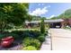 Beautiful brick home featuring mature landscaping, colorful flowers, and a covered carport at 3008 Imperial Dr, Gastonia, NC 28054