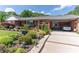 Brick home with a neatly landscaped front yard featuring diverse plantings and covered carport at 3008 Imperial Dr, Gastonia, NC 28054