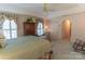 Bright main bedroom featuring a tray ceiling, floral curtains, a ceiling fan, and a cozy sitting area with a chaise lounge at 3008 Imperial Dr, Gastonia, NC 28054