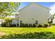 Spacious backyard featuring lush green grass and mature landscaping; perfect for outdoor enjoyment and relaxation at 3129 Summerfield Ridge Ln, Matthews, NC 28105