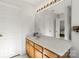 Bathroom with oak cabinets, spacious counter, and a large mirror at 3129 Summerfield Ridge Ln, Matthews, NC 28105