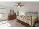 Bright bedroom with a decorative metal bed frame, dresser, and two windows at 3129 Summerfield Ridge Ln, Matthews, NC 28105