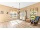 Bright dining room with a rocking chair, a modern chandelier, and natural light for a warm and inviting atmosphere at 3129 Summerfield Ridge Ln, Matthews, NC 28105
