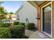Charming front door entrance with lush bushes and an ornate, decorative door hanger at 3129 Summerfield Ridge Ln, Matthews, NC 28105