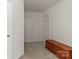 Upstairs hallway featuring white walls, carpeting, and a wooden storage chest at 3129 Summerfield Ridge Ln, Matthews, NC 28105