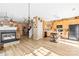 Open-concept living room and kitchen with modern fireplace, wood floors, and natural light, creating an inviting space at 3129 Summerfield Ridge Ln, Matthews, NC 28105