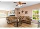 Cozy living room featuring hardwood floors, a fireplace, and natural light from a window at 3129 Summerfield Ridge Ln, Matthews, NC 28105
