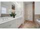 Bright bathroom featuring a double vanity, decorative plants, and a separate tub and shower space at 330 Horton Grove Rd, Fort Mill, SC 29715