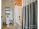 Bathroom featuring a bathtub with shower, toilet, and decorative wall art at 330 Horton Grove Rd, Fort Mill, SC 29715