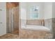 Bathroom featuring a glass shower, soaking tub and window with a view at 330 Horton Grove Rd, Fort Mill, SC 29715