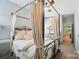 Bedroom featuring a stylish canopy bed with side table and view of open doorway at 330 Horton Grove Rd, Fort Mill, SC 29715
