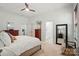 Bright bedroom featuring a plush bed, multiple windows, ceiling fan, and modern furniture at 330 Horton Grove Rd, Fort Mill, SC 29715