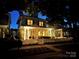 Charming two-story home with a welcoming front porch, picket fence, and illuminated by warm lights at twilight at 330 Horton Grove Rd, Fort Mill, SC 29715