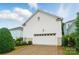 View of the home's rear garage with white siding and a driveway at 330 Horton Grove Rd, Fort Mill, SC 29715