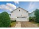 A well maintained white garage door beneath a matching house featuring a small window near the roof's peak at 330 Horton Grove Rd, Fort Mill, SC 29715