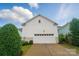 View of the home's rear garage with white siding and a driveway at 330 Horton Grove Rd, Fort Mill, SC 29715