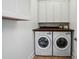 Functional laundry room featuring side-by-side washer and dryer, cabinets, and countertop space at 330 Horton Grove Rd, Fort Mill, SC 29715