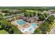 Community pool area featuring a splash pad, swimming pool, and plenty of lounge chairs on a sunny day at 330 Horton Grove Rd, Fort Mill, SC 29715