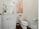 Cozy powder room with decorative painting, toilet, and sink with vanity cabinet at 330 Horton Grove Rd, Fort Mill, SC 29715