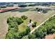 Expansive aerial view of a home and farm surrounded by green fields and a dense forest at 335&315 Graham Rd, Mt Ulla, NC 28125