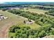 Stunning aerial view of a property with lush greenery, fields, and a winding road at 335&315 Graham Rd, Mt Ulla, NC 28125
