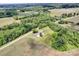 Aerial view showcasing the charming property bordered by verdant trees and sprawling farmland, a serene rural oasis at 335&315 Graham Rd, Mt Ulla, NC 28125