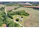 An aerial view showcases a property surrounded by lush farmland and verdant trees, blending rural charm and peaceful seclusion at 335&315 Graham Rd, Mt Ulla, NC 28125