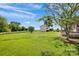 Expansive backyard with a white building, lush green grass, and beautiful blue sky at 335&315 Graham Rd, Mt Ulla, NC 28125