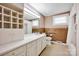Bright bathroom with dual sinks, ample counter space, built-in shelves, and a shower-tub combination at 335&315 Graham Rd, Mt Ulla, NC 28125