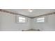 Bright bedroom with two windows, white walls, neutral carpet and an ornamental wallpaper border at 335&315 Graham Rd, Mt Ulla, NC 28125
