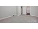 Neutral bedroom featuring soft carpeting and a closet with open doors, creating a cozy and functional retreat at 335&315 Graham Rd, Mt Ulla, NC 28125