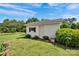 View of the outbuilding with white brick, a door, a small window, and a well-maintained lawn at 335&315 Graham Rd, Mt Ulla, NC 28125