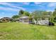 Exterior view of the home highlighting the backyard, screened porch, and lush greenery at 335&315 Graham Rd, Mt Ulla, NC 28125