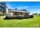 Exterior of a brick house featuring a covered porch, well-maintained lawn, and mature trees at 335&315 Graham Rd, Mt Ulla, NC 28125