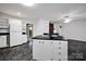 Bright kitchen featuring white cabinets, a black countertop island, and unique marble-patterned flooring at 335&315 Graham Rd, Mt Ulla, NC 28125