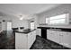 Bright kitchen with white cabinetry, black countertops, and a classic layout, blending functionality and vintage style at 335&315 Graham Rd, Mt Ulla, NC 28125
