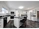 Spacious kitchen featuring white cabinets, black countertops, and black and white tiled backsplash, a blend of style and functionality at 335&315 Graham Rd, Mt Ulla, NC 28125