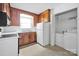Kitchen with wood cabinetry, a white refrigerator, laundry area, and plenty of natural light at 335&315 Graham Rd, Mt Ulla, NC 28125