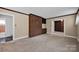 Comfortable living room with a brick accent wall, built-in shelving, and multiple doorways at 335&315 Graham Rd, Mt Ulla, NC 28125