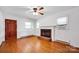 Bright living room with hardwood floors, a brick fireplace, and large windows providing natural light at 335&315 Graham Rd, Mt Ulla, NC 28125
