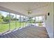 Relaxing screened porch with wood flooring, and a view of the lush backyard and outbuildings at 335&315 Graham Rd, Mt Ulla, NC 28125