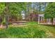 Expansive backyard with a pergola, raised garden beds, and a lush green lawn at 3617 Ruth St, Indian Trail, NC 28079