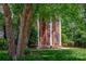Elegant brick home showcasing white pillars, a well-manicured lawn, and mature trees at 3617 Ruth St, Indian Trail, NC 28079
