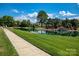 Scenic community pond with lush greenery, walking path, and serene landscaping at 3617 Ruth St, Indian Trail, NC 28079