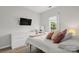 Bright bedroom with a large window, soft color scheme and a mounted TV for added entertainment at 3820 Leela Palace Way, Fort Mill, SC 29708